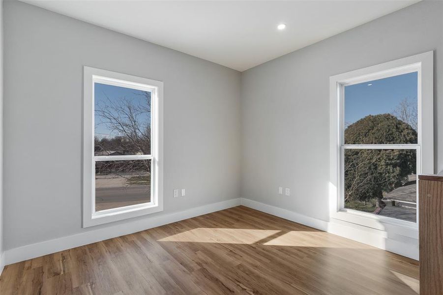 Spare room featuring light hardwood / wood-style floors and a wealth of natural light