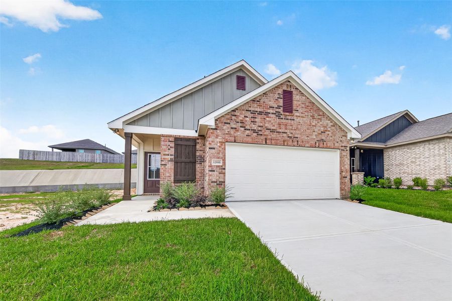 Front exterior of a new home in Mostyn Springs, Magnolia, TX, highlighting curb appeal (Image 2). Front exterior of a new home in Mostyn Springs, Magnolia, TX, highlighting curb appeal (Image 2).