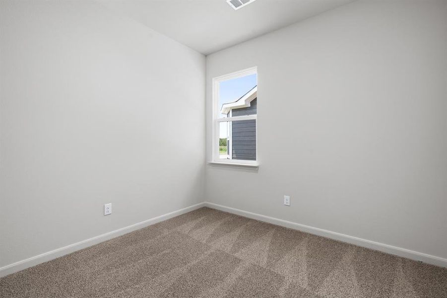 Carpeted empty room with baseboards Carpeted empty room with baseboards