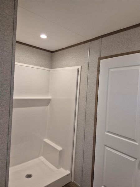 Full bathroom featuring a stall shower, recessed lighting, and crown molding