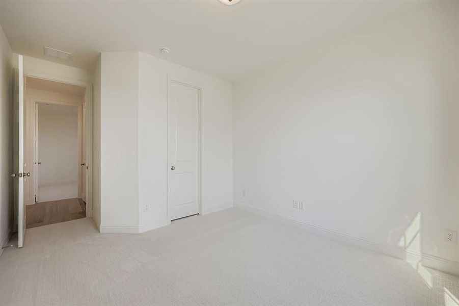 Unfurnished bedroom featuring carpet flooring and baseboards