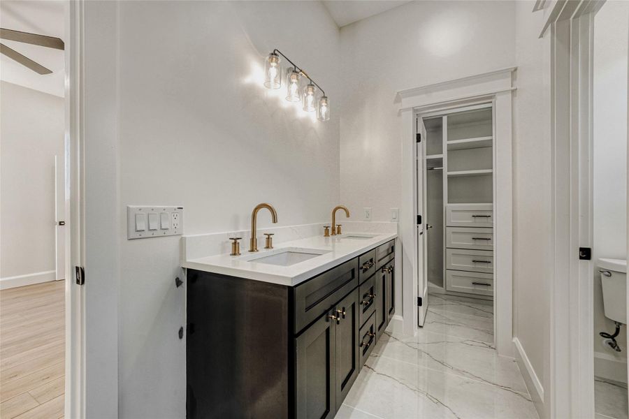 The spa-inspired ensuite bath features a spacious quartz topped vanity with modern fixtures and hardware.