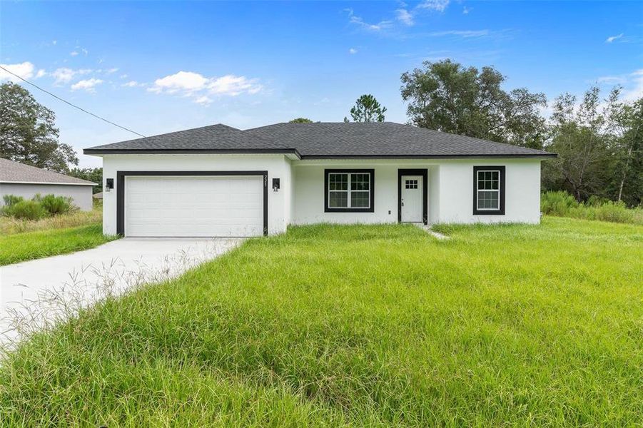 Front exterior of a new home in , Ocklawaha, FL, highlighting curb appeal (Image 16).