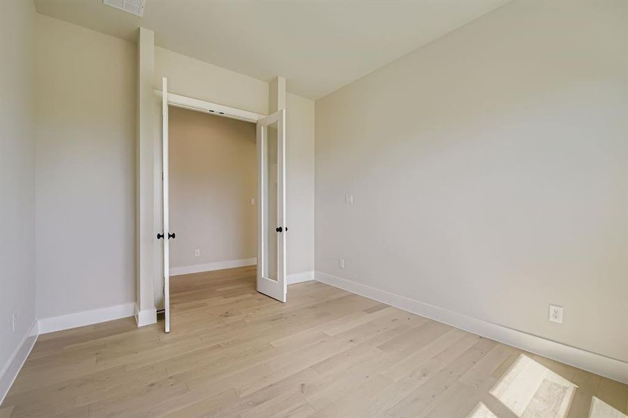 Spare room with light wood finished floors and baseboards