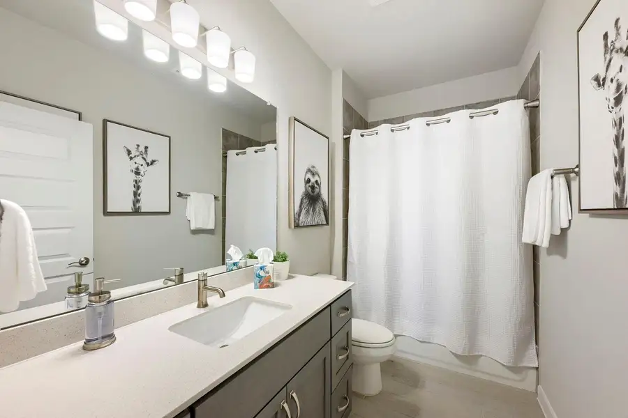 A well-lit bathroom with ample counter space and convenient shower/tub combination. A well-lit bathroom with ample counter space and convenient shower/tub combination.
