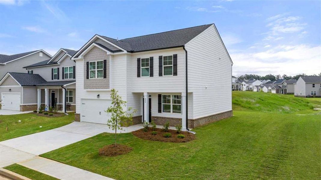 Front exterior of a new home in Champion's Run, Lithonia, GA, highlighting curb appeal (Image 16). Front exterior of a new home in Champion's Run, Lithonia, GA, highlighting curb appeal (Image 16).