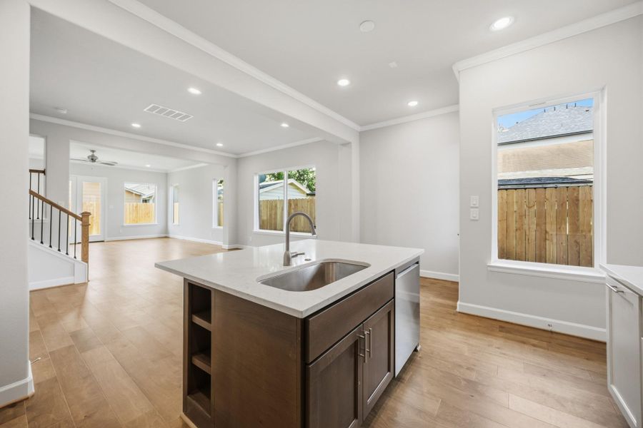 The heart of the home. Anchored by an island with a sink and ample pantry storage, this kitchen is where memories are made.