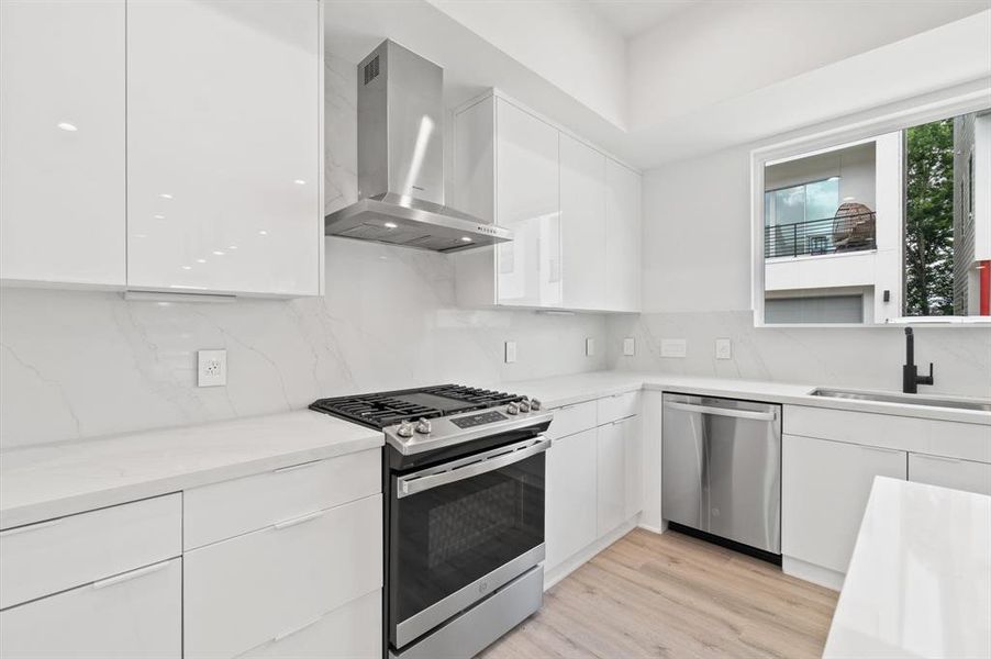 Open flow kitchen with custom European cabinetry.