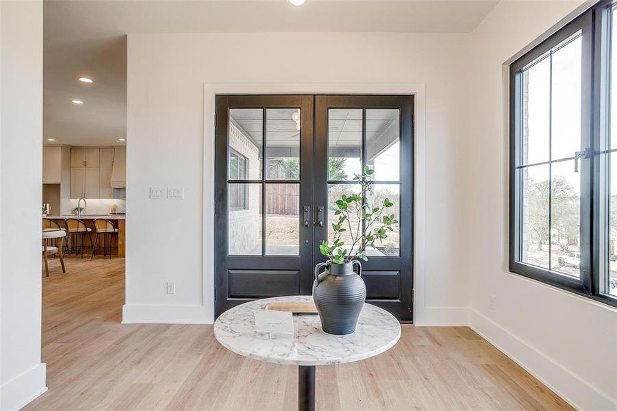 Entrance foyer with recessed lighting, french doors, baseboards, and light wood finished floors