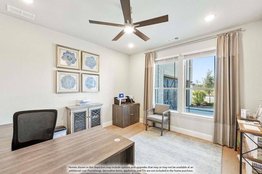 Home office with wood desk, ceiling fan, hardwood floors, and large window with natural light