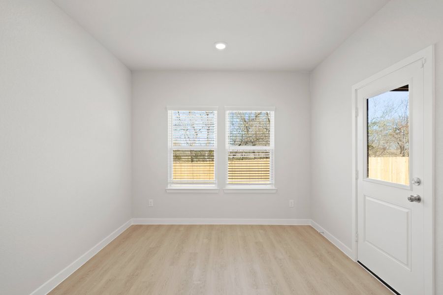 A room with a wood floor and a wood floor with a white door. A room with a wood floor and a wood floor with a white door.