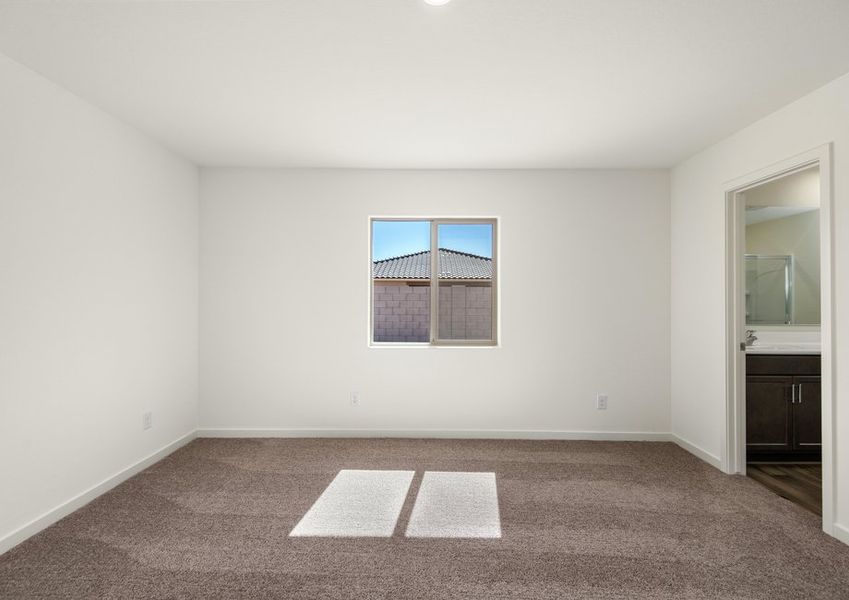 The master bedroom seamlessly connects to the spacious bathroom.