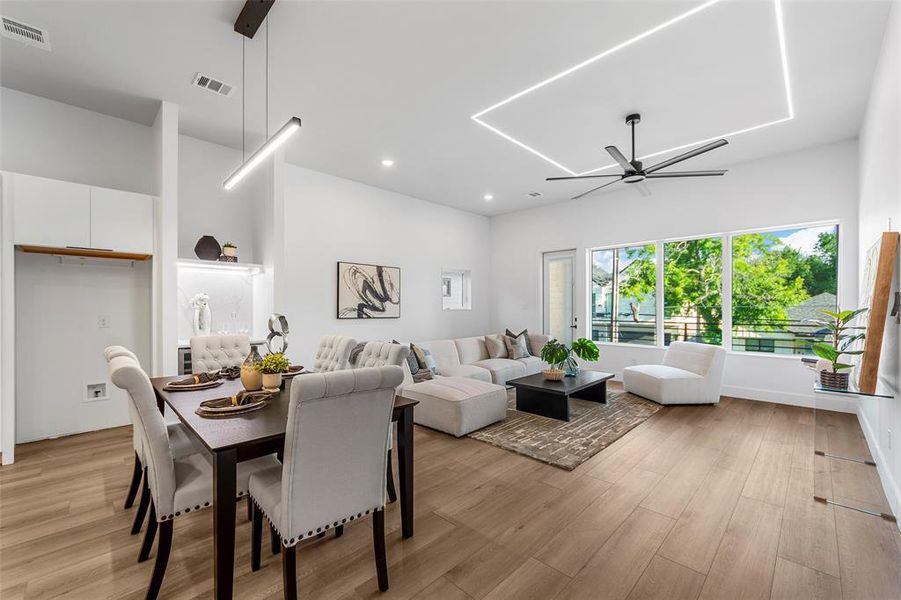 Dining room with a ceiling fan, light wood finished floors, and recessed lighting Dining room with a ceiling fan, light wood finished floors, and recessed lighting