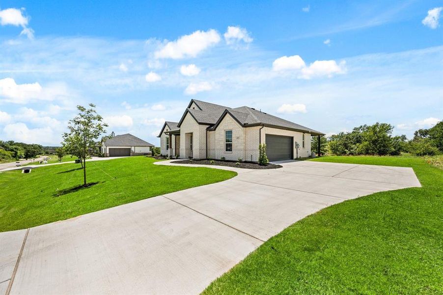 Front exterior of a new home in Saddleback Estates, Boyd, TX, highlighting curb appeal (Image 2).