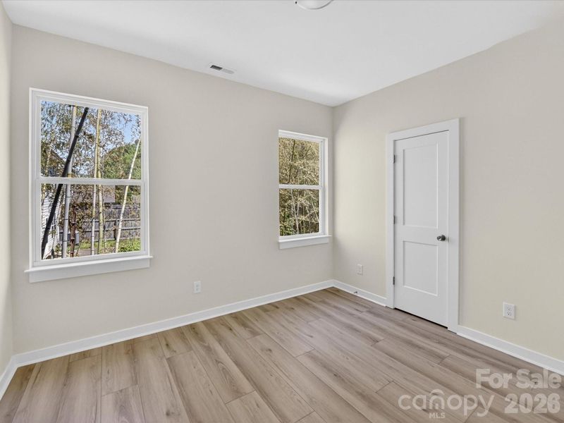 Spacious secondary bedroom features great natural light and a flexible layout, ideal for use as a guest room, home office, or cozy personal retreat.