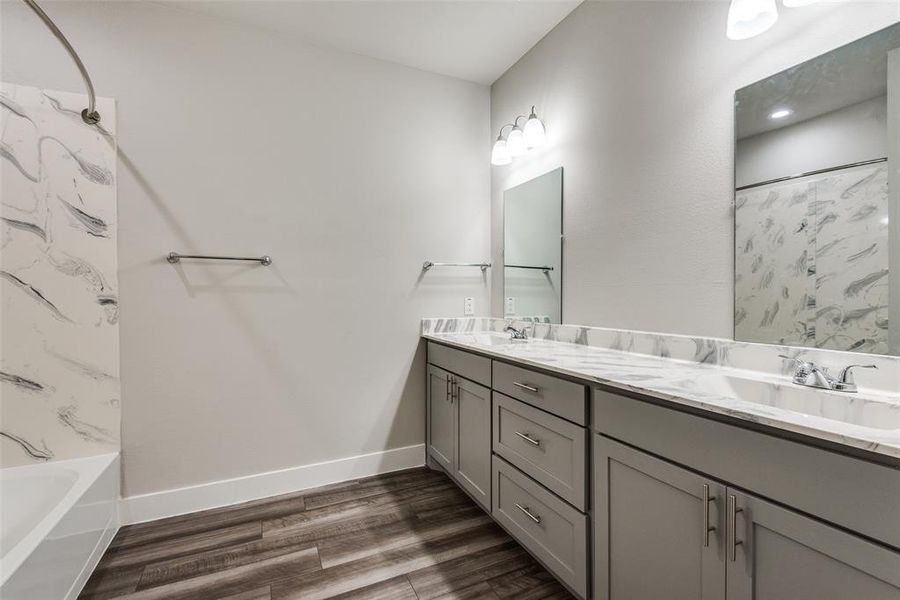 Bathroom with a tub/shower and a double sink