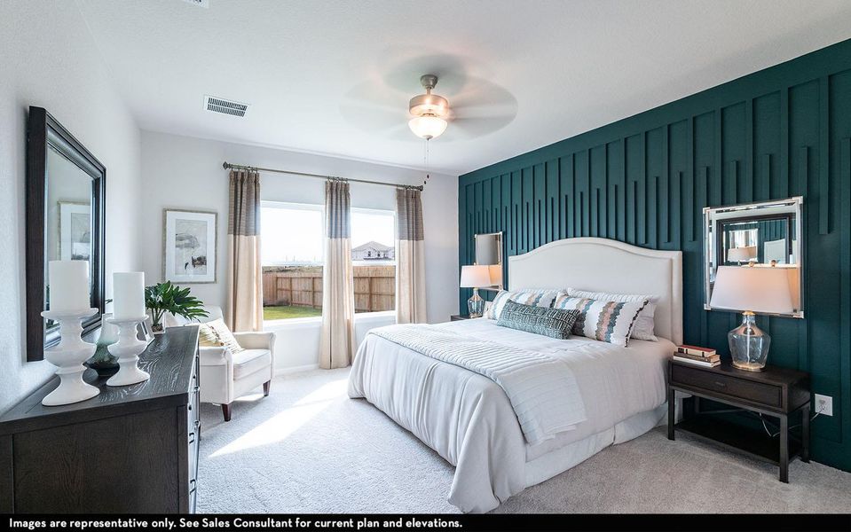 Carpeted bedroom with an accent wall and a ceiling fan