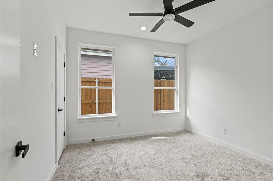 Empty room with carpet flooring and ceiling fan