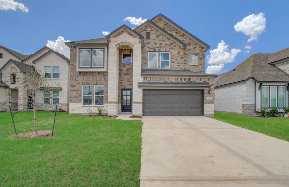 Front exterior of a new home in Harmony Cove, Humble, TX, highlighting curb appeal (Image 24).