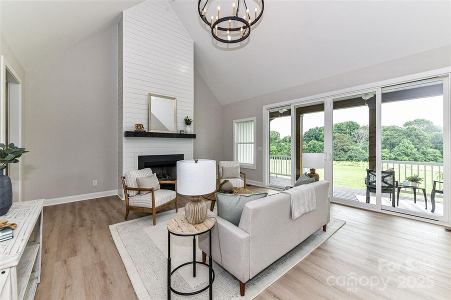 Vaulted Great Room features gas, ship lap fireplace, custom light fixture, LVP floors with access to covered deck! Vaulted Great Room features gas, ship lap fireplace, custom light fixture, LVP floors with access to covered deck!