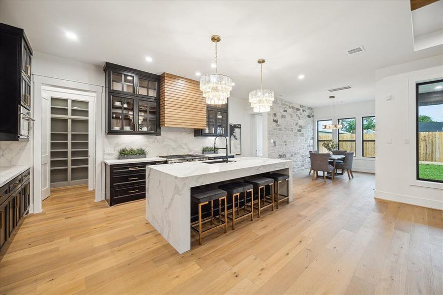 This chef's kitchen features a GE Cafe stainless steel dishwasher, a Dual fuel range wtih gas burners, a built in microwave and refrigerator with water and ice dispenser.