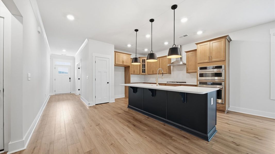 Expansive kitchen offering exceptional workspace and effortless flow to adjacent living areas by DRB Homes