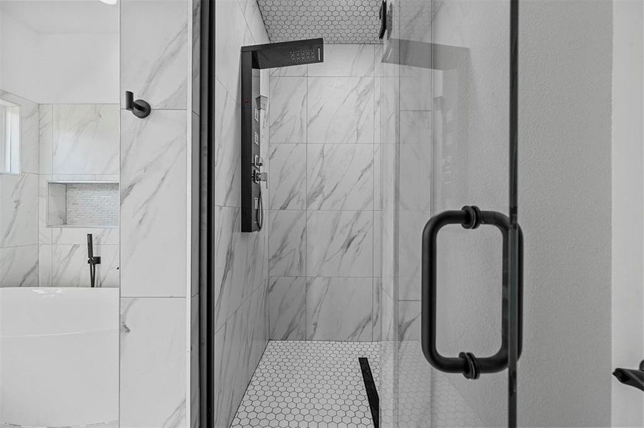 Bathroom featuring a shower with door