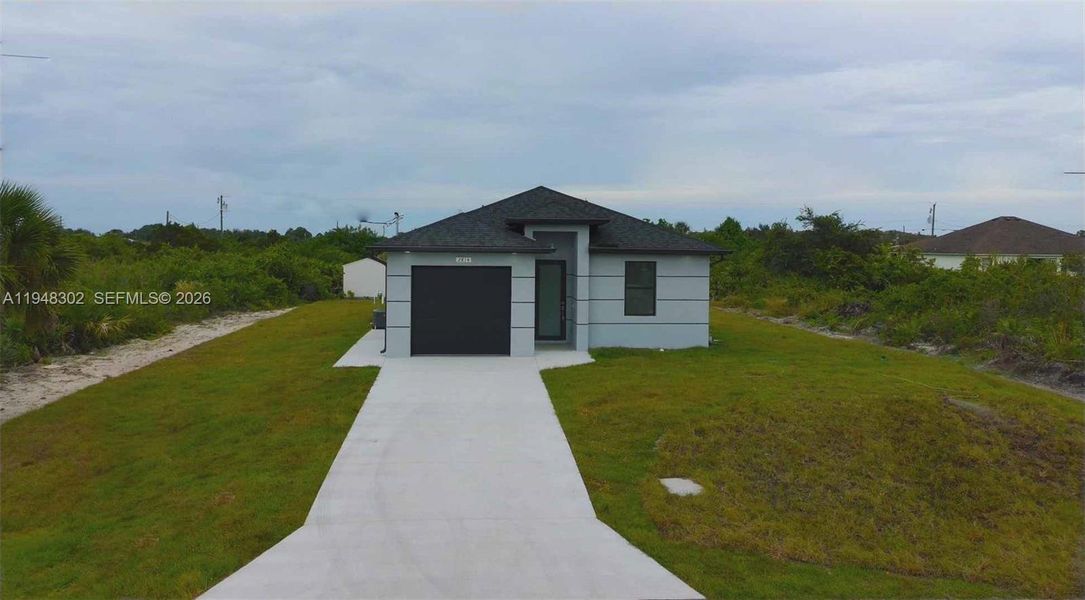 Front exterior of a new home in , Lehigh Acres, FL, highlighting curb appeal (Image 23).
