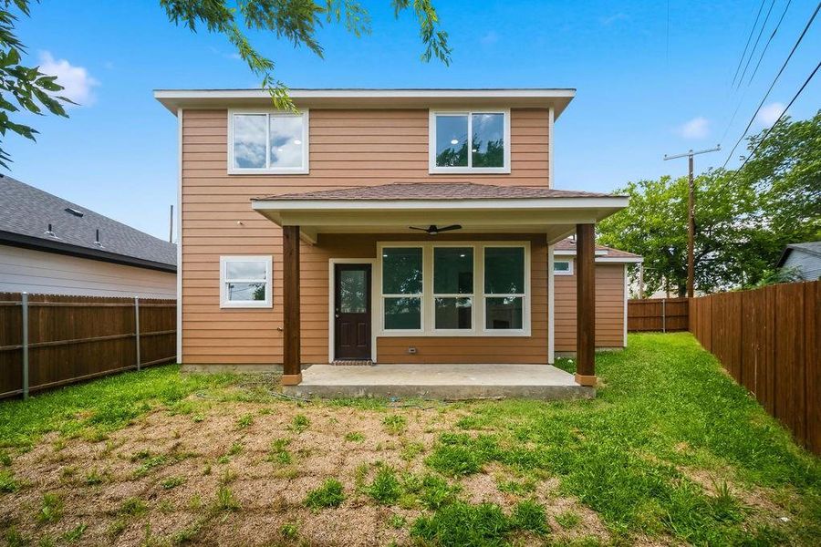 Two-story residence featuring horizontal siding, multiple windows, and a covered back patio Two-story residence featuring horizontal siding, multiple windows, and a covered back patio