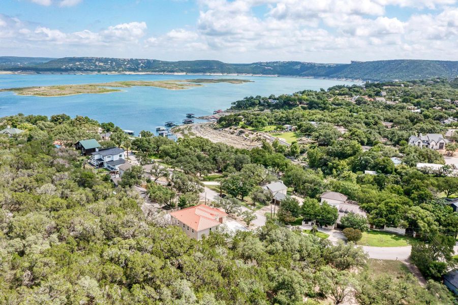 Aerial view of residential area featuring a nearby body of water