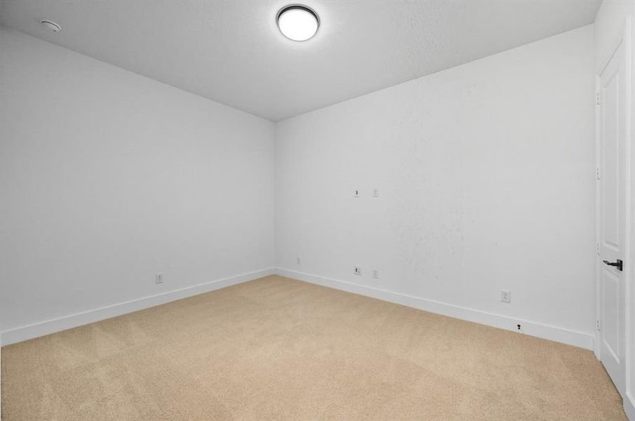 Spare room featuring light carpet and baseboards Spare room featuring light carpet and baseboards