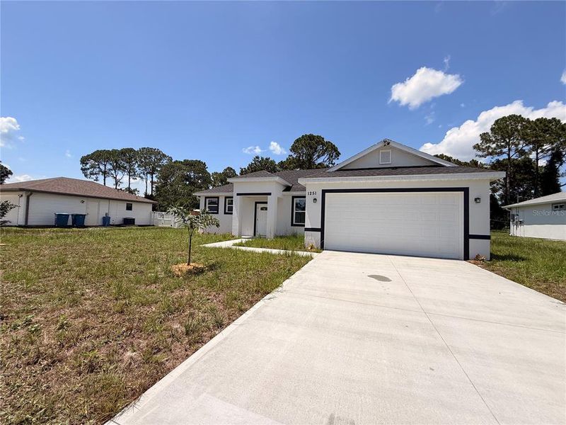 Front exterior of a new home in , Palm Bay, FL, highlighting curb appeal (Image 2). Front exterior of a new home in , Palm Bay, FL, highlighting curb appeal (Image 2).