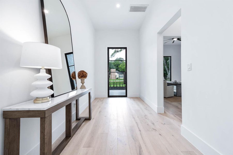 Grand entryway with soaring 12-foot ceilings, creating an open and welcoming atmosphere.