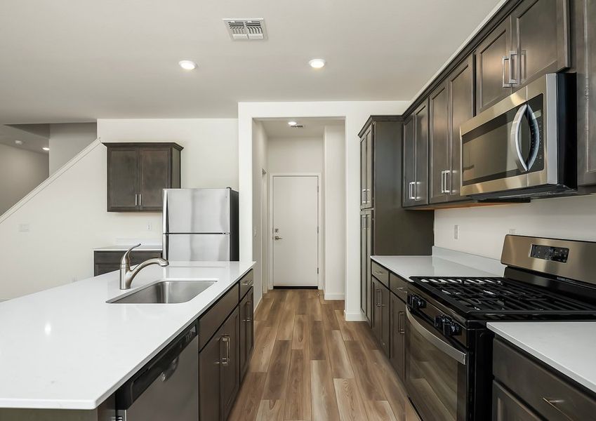 Kitchen with stainless gas range and quartz countertops in Wellton floor plan