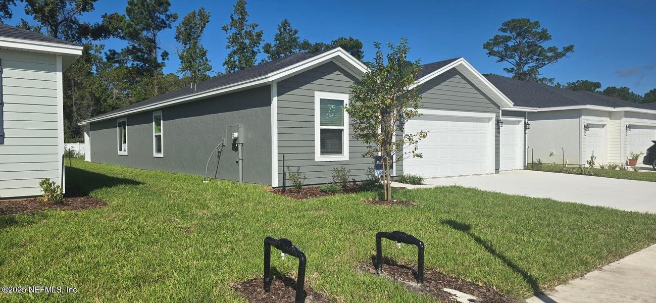 Front exterior of a new home in Azalea Creek, Jacksonville, FL, highlighting curb appeal (Image 1).
