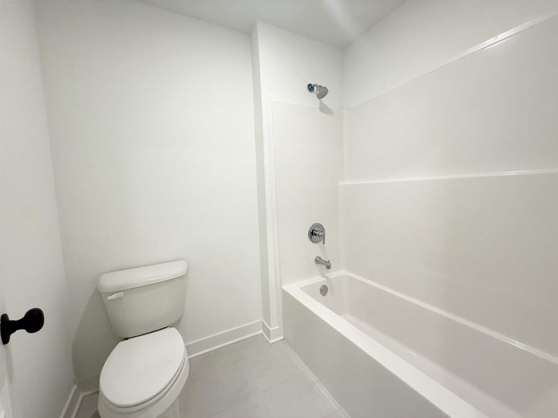 Bathroom featuring shower / tub combination and light tile patterned flooring