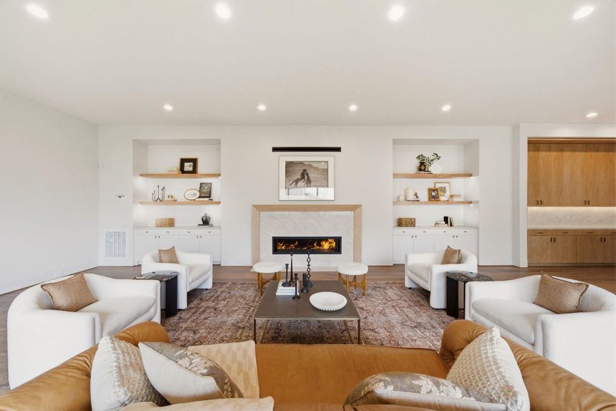 Refined living area centered around a statement fireplace and custom built-ins.