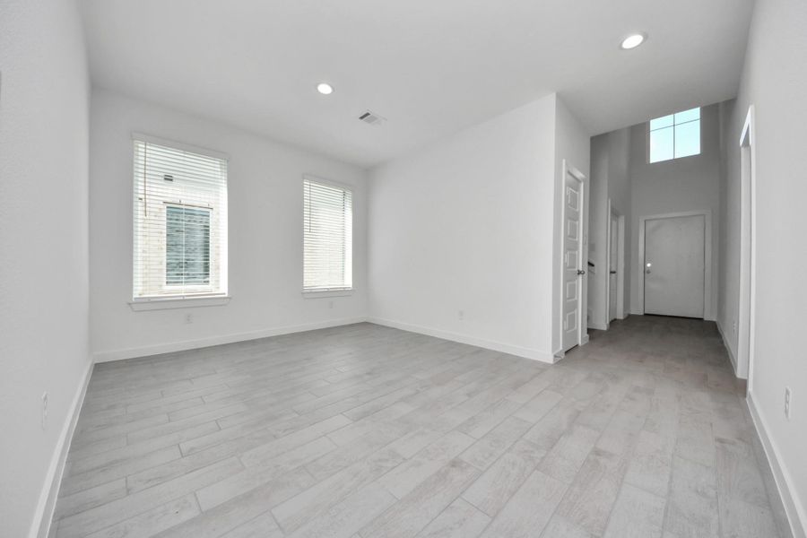 Make memories gathered around the table with your family and friends! This spacious dining room features elegant flooring, custom paint, and adjacent to family room and kitchen for open concept feel. Sample photo of completed home with similar floor plan. Actual colors and selections may vary.