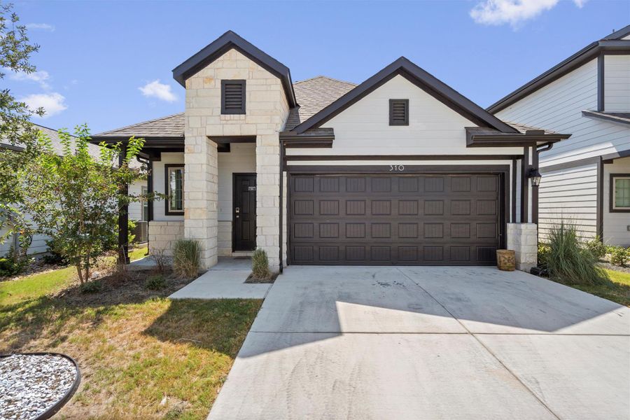 Front exterior of a new home in The Ridge at Trinity Ranch, Elgin, TX, highlighting curb appeal (Image 2).