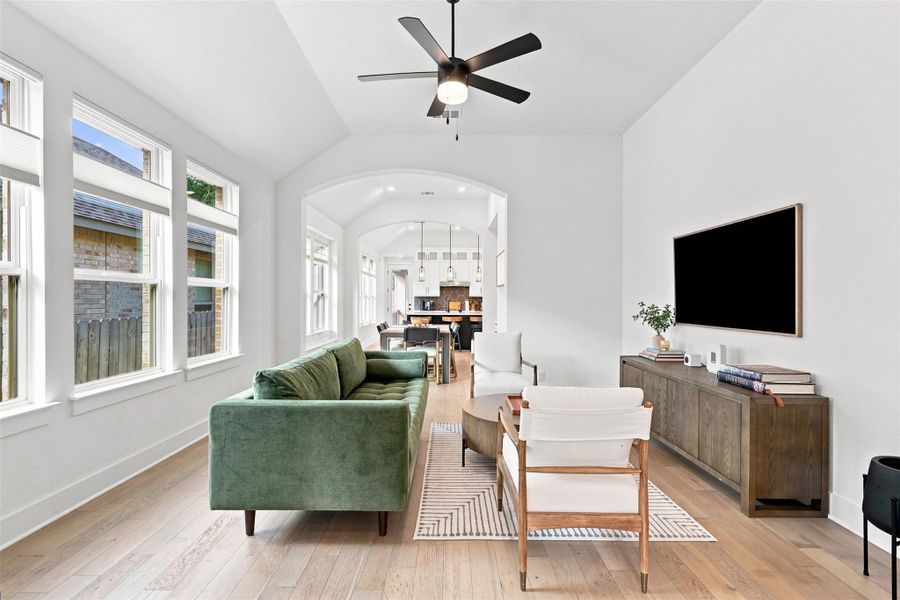 Hardwood floors and arched transitions define this airy interior living space.
