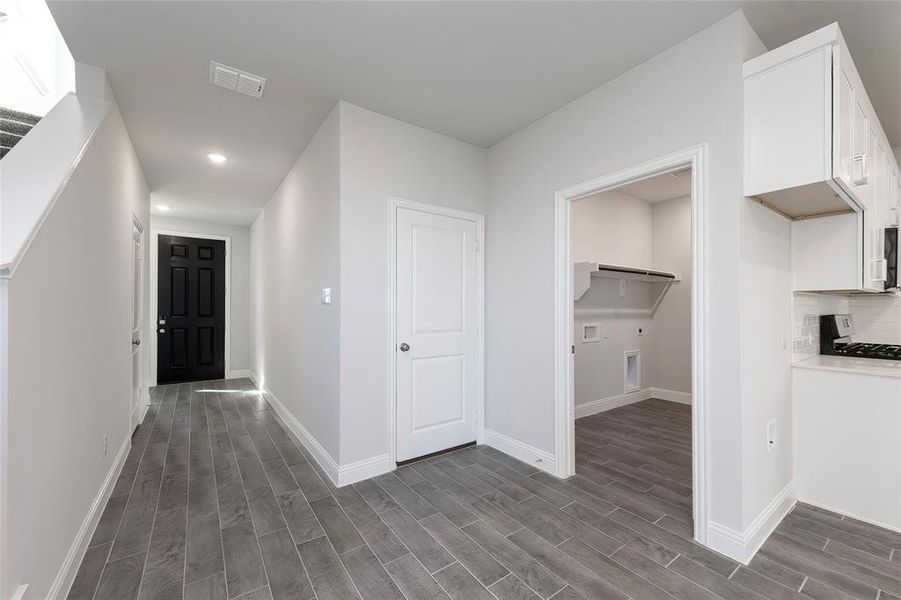 Hall featuring dark wood-style flooring, recessed lighting, and baseboards Hall featuring dark wood-style flooring, recessed lighting, and baseboards