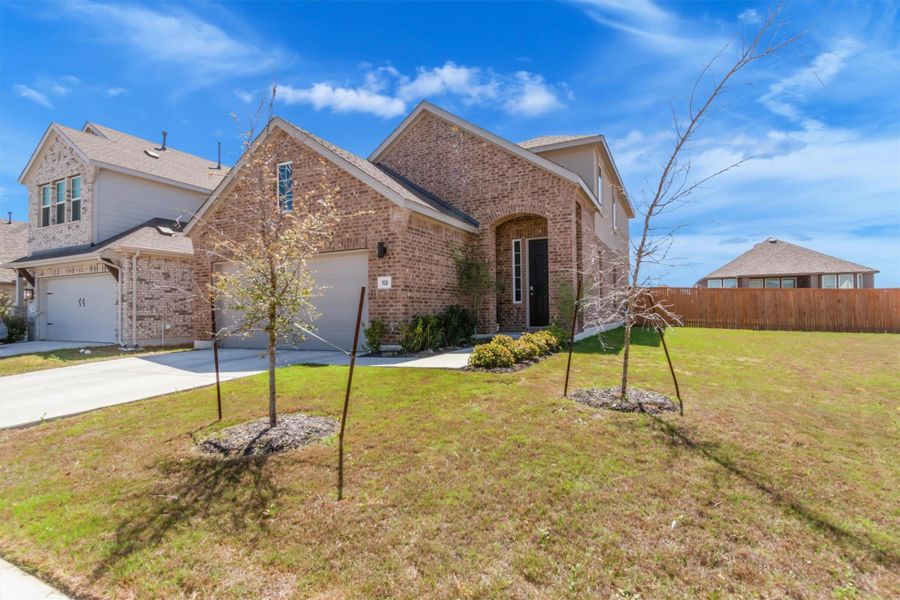 Front exterior of a new home in Crosswinds, Kyle, TX, highlighting curb appeal (Image 25).