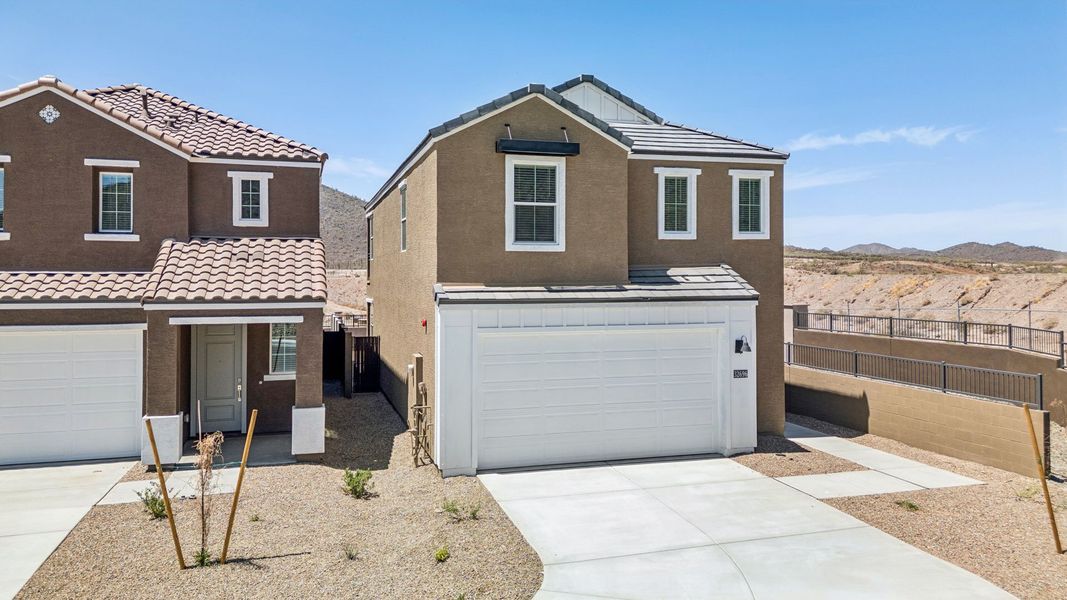 Front exterior of a new home in The Buttes at Mystic, Peoria, AZ, highlighting curb appeal (Image 2). Front exterior of a new home in The Buttes at Mystic, Peoria, AZ, highlighting curb appeal (Image 2).