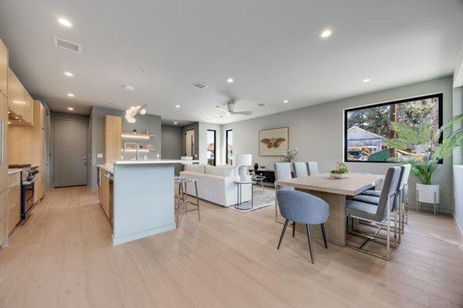 The living dining and kitchen flow together yet offer distinct gathering areas.