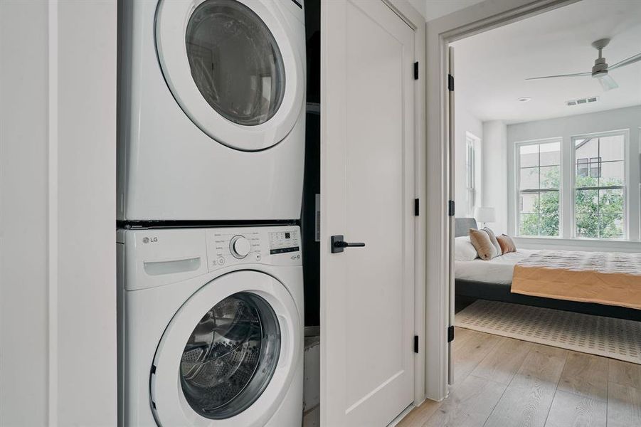 Integrated stacked laundry appliances within a dedicated closet