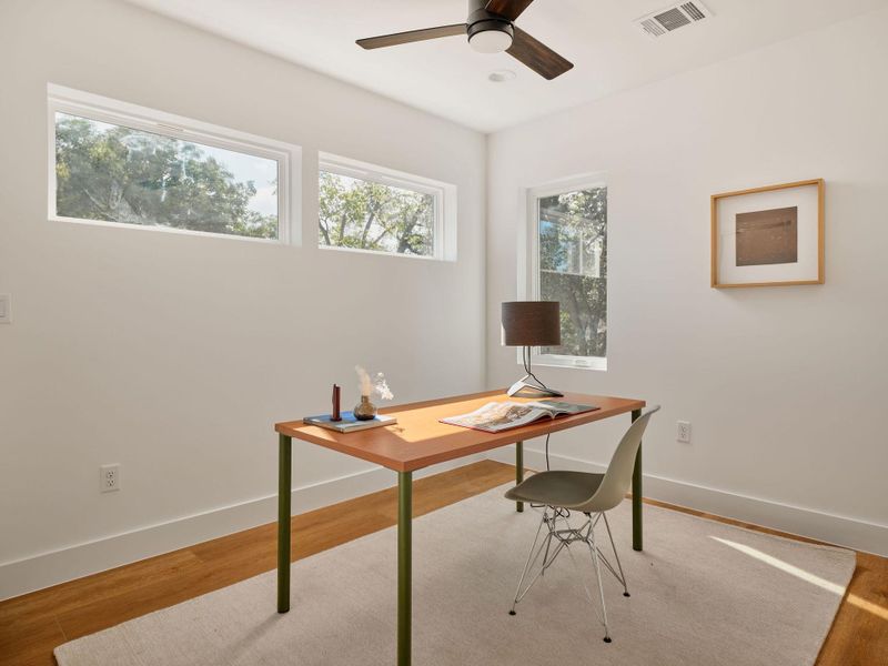 Office featuring light wood finished floors and a ceiling fan Office featuring light wood finished floors and a ceiling fan