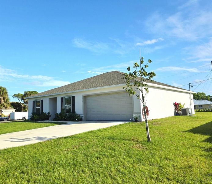 Front exterior of a new home in , Port St. Lucie, FL, highlighting curb appeal (Image 8).