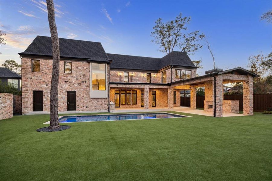 The backyard is a pristine outdoor haven that complements the grandeur of the home. The artificial turf provides a lush green aesthetic with minimal maintenance.