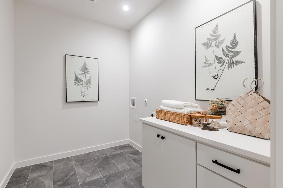 Washroom with washer hookup, cabinet space, and recessed lighting