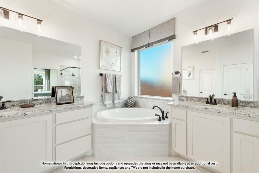Master bathroom with dual vanities, granite countertops, soaking tub, and frosted window between two large mirrors